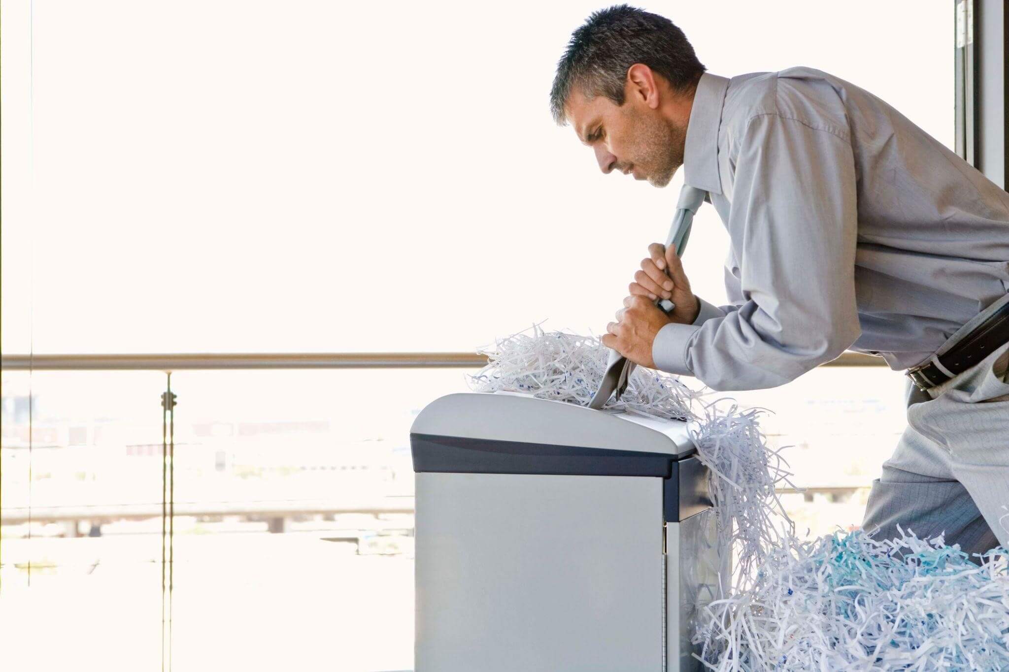 man is shredding paper